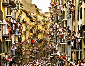 People watch as Jandilla fighting bulls and revelers run during the running of the bulls, at the San Fermin festival, in Pamplona, Spain, Tuesday, July 7, 2015. Revelers from around the world arrive to Pamplona every year to take part in the eight days of the running of the bulls. (AP Photo/Andres Kudacki)
